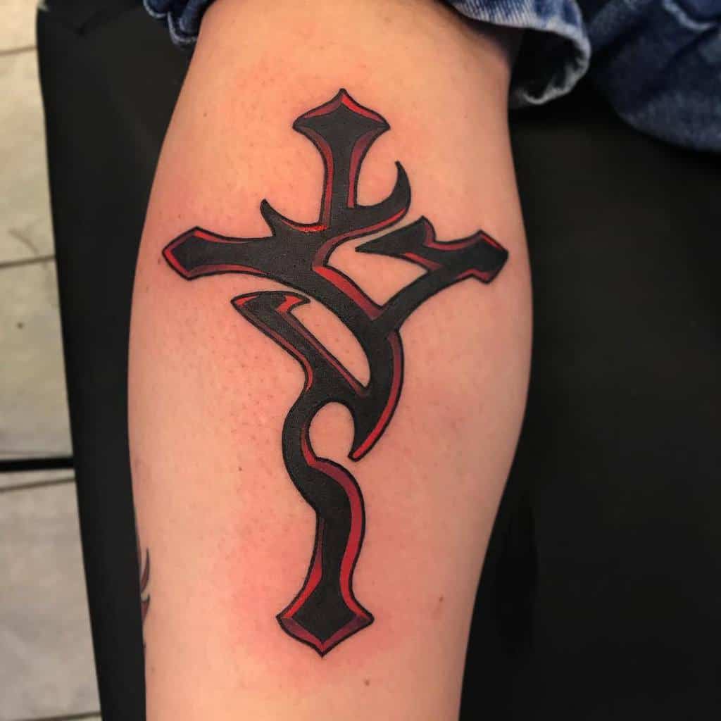 Tattoo on a person's arm featuring a black cross with red outlining