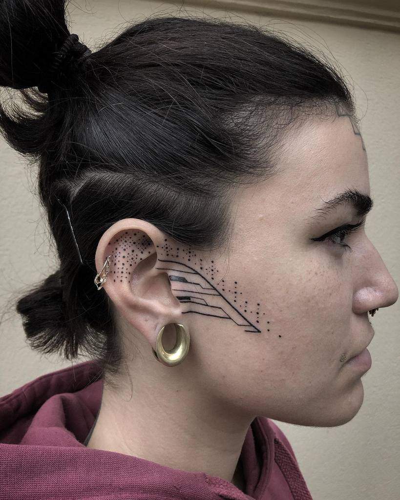 Tribal-inspired face tattoos featuring geometric lines and dot patterns around the ear and cheek