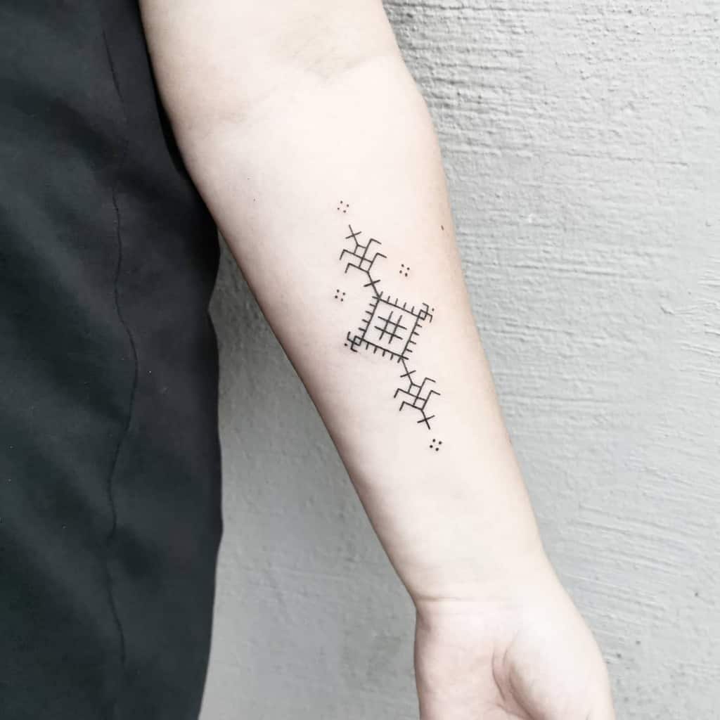 Minimalistic geometric tattoo with symmetrical lines and shapes on a forearm