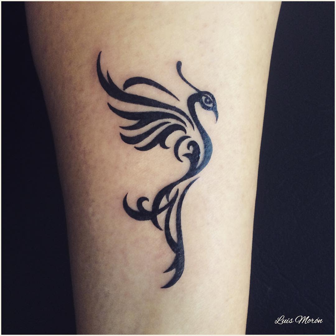 Black tribal-style phoenix tattoo