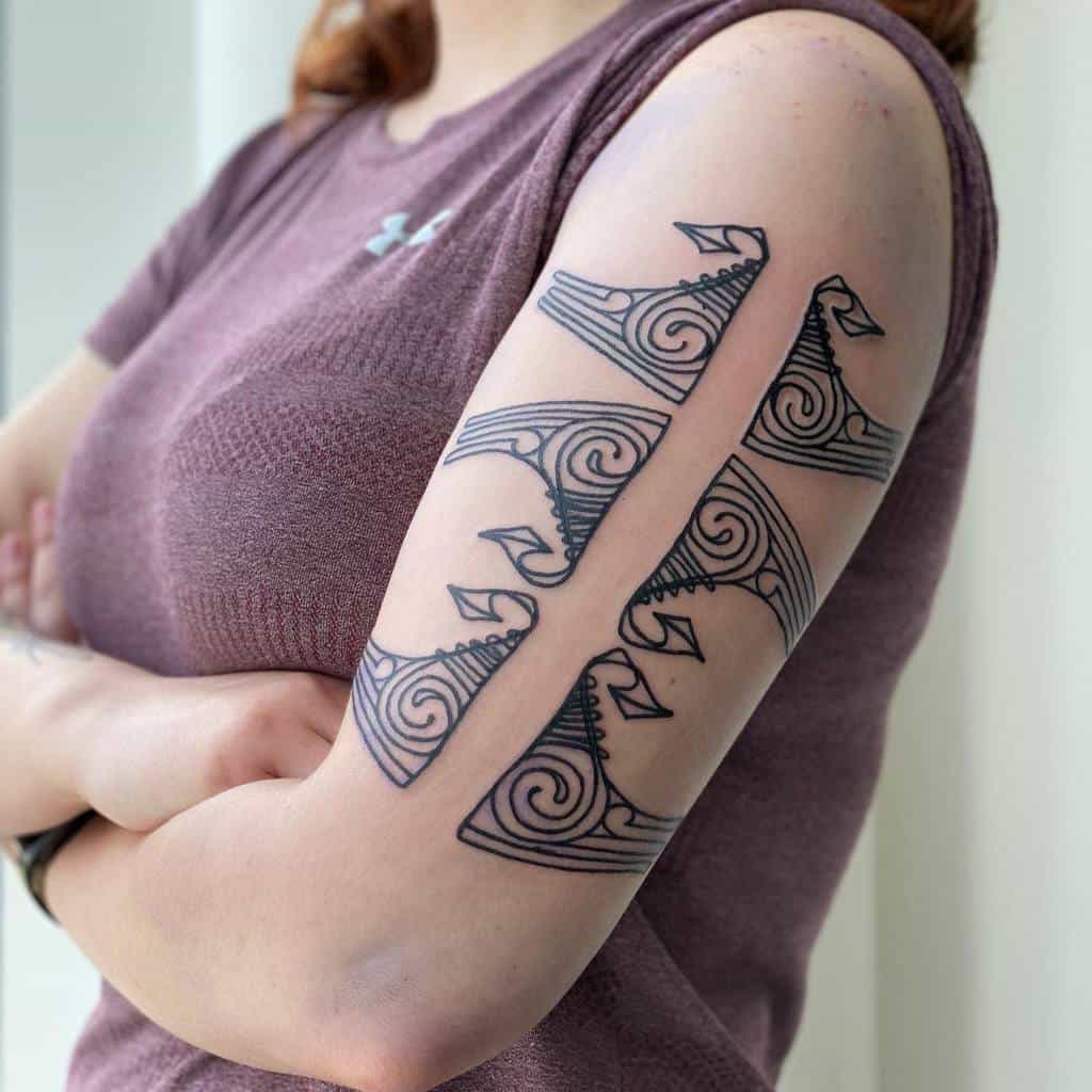 Woman with spiral wave tattoos on arm
