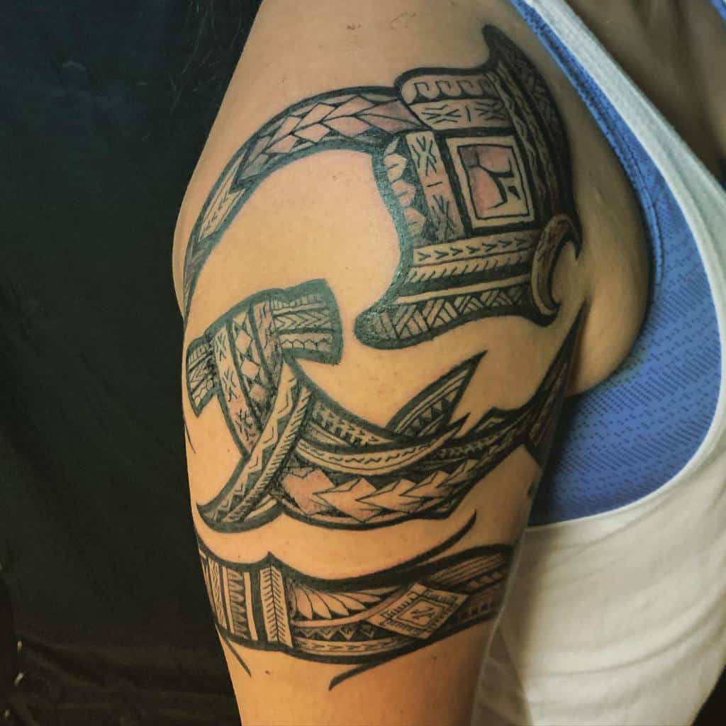 Arm tattoo of a detailed Polynesian tribal design on the upper arm