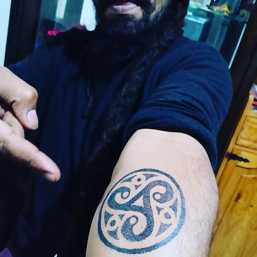 Triskelion tattoo on the arm
