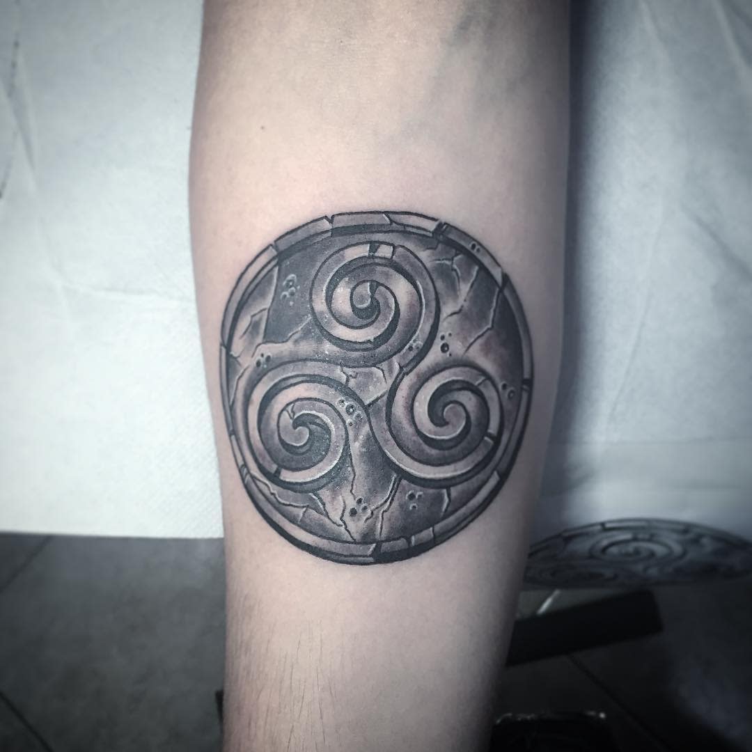 Triskelion tattoo on a forearm