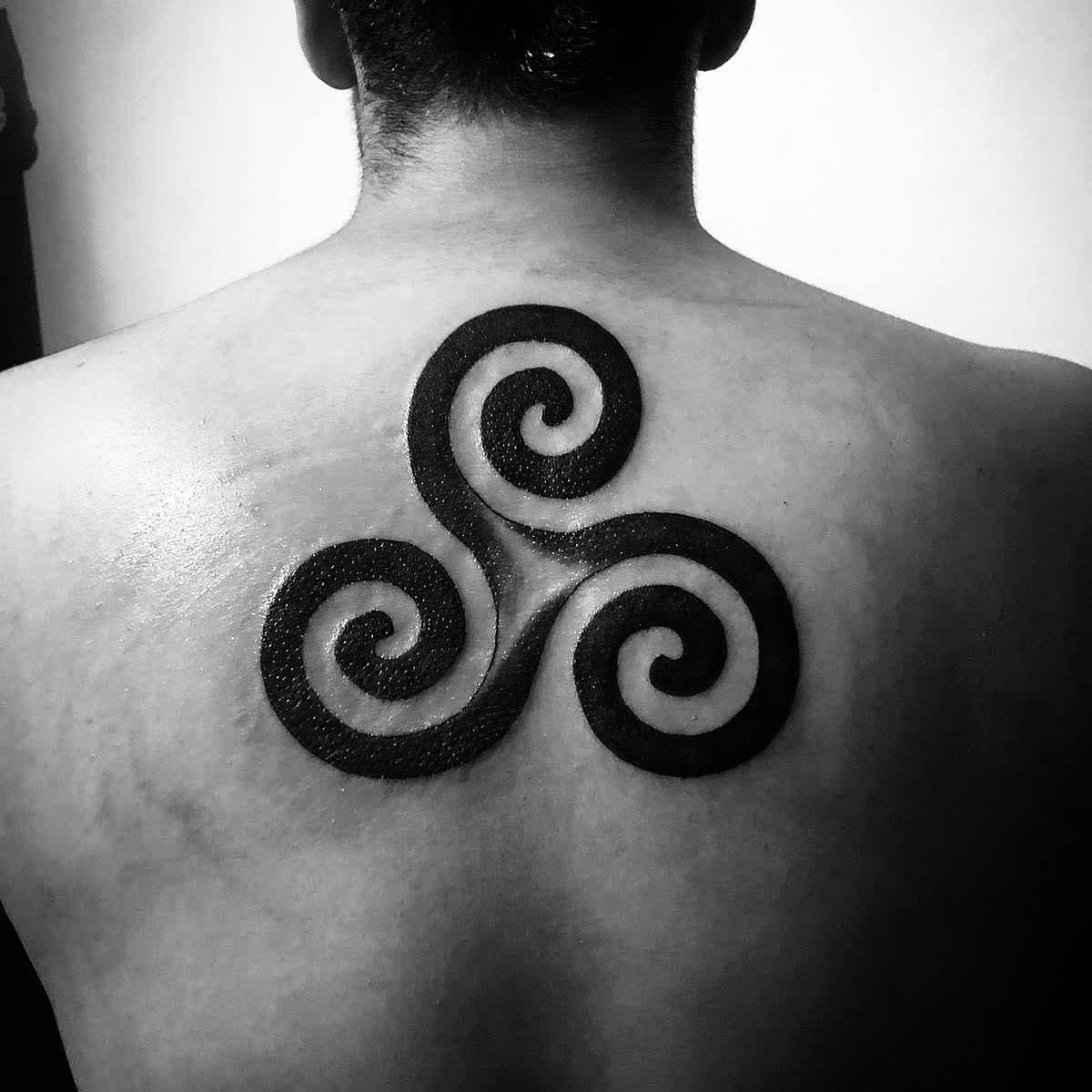 Black Triskelion Upper Back Tattoo