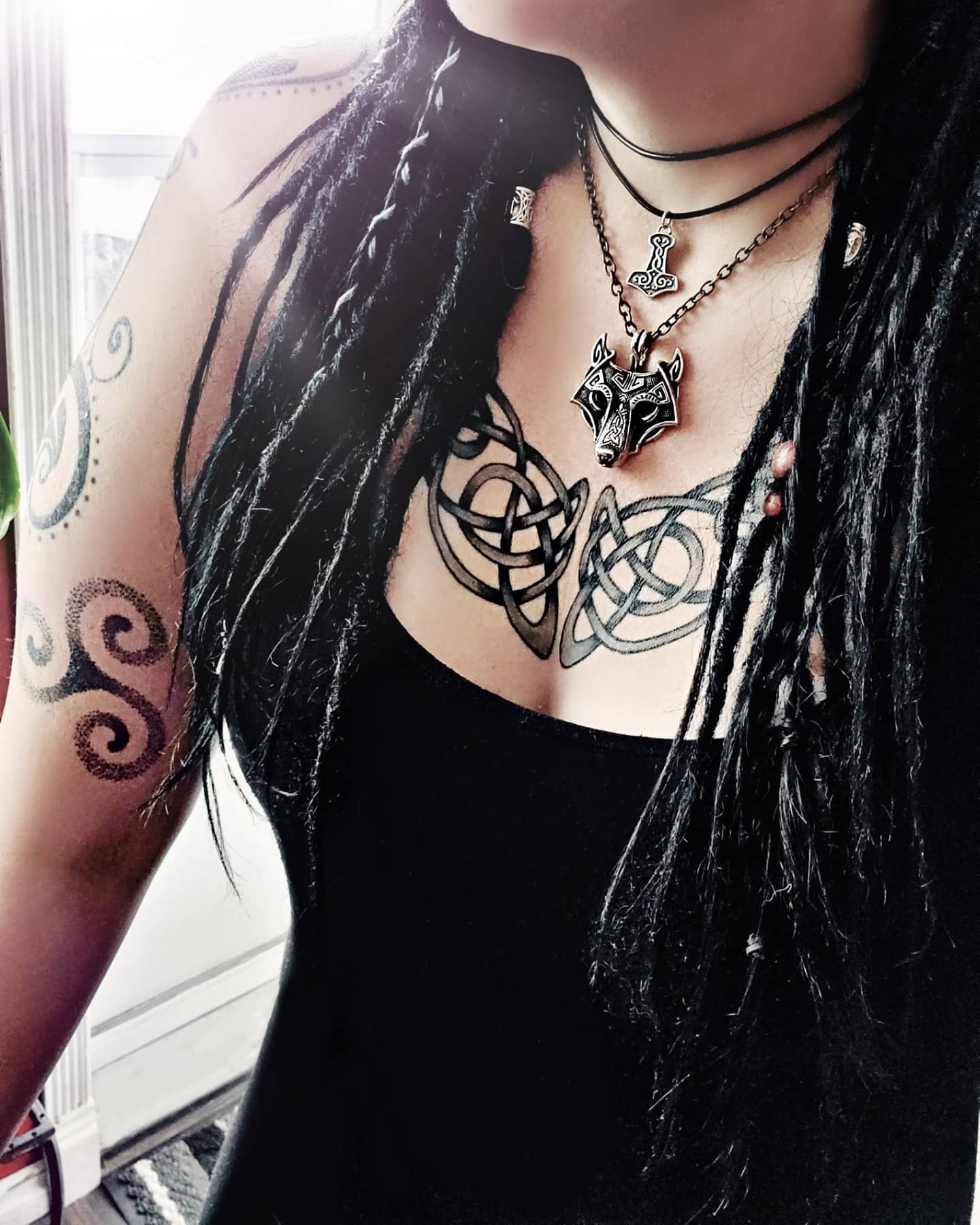 Arm and chest tattoos featuring Triskelions and Celtic knots, symbolizing strength and heritage