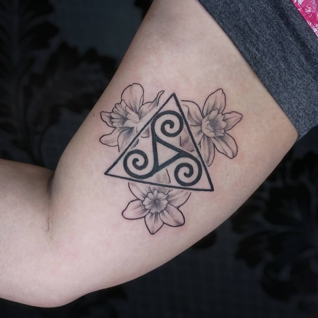 Feminine Triskelion Tattoo-querubintatts Arm tattoo of a Triskelion within a triangle, surrounded by flowers, symbolizing harmony and growth