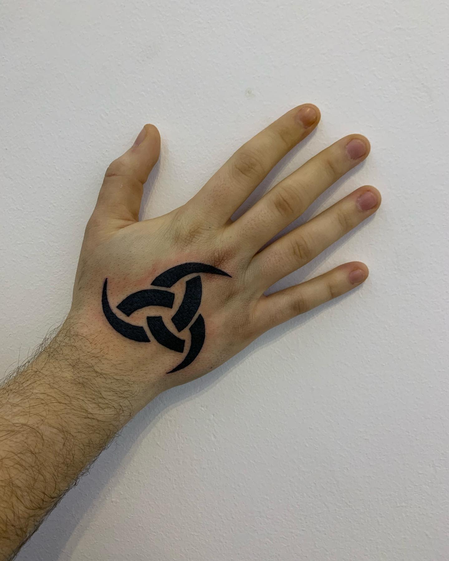Triskele, the Triple Horn of Odin tattoo on hand