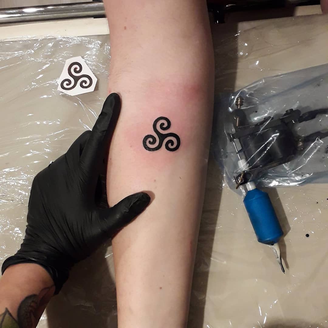 Small Triskelion Tattoo on a Forearm