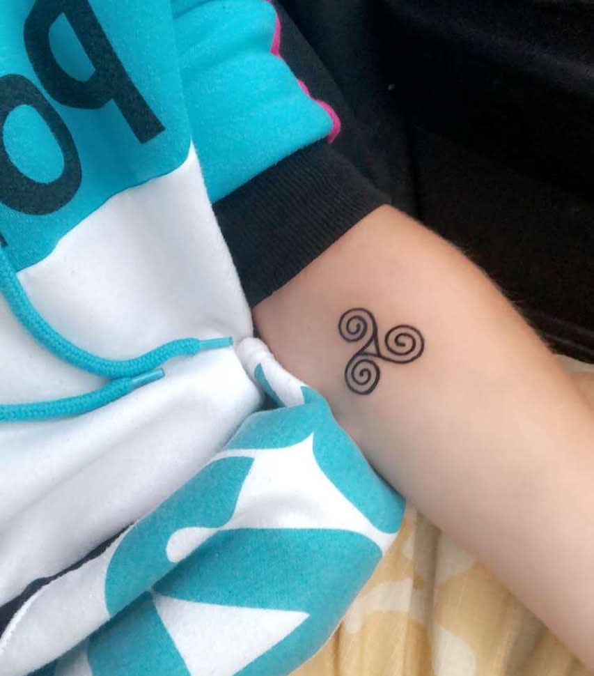 Small Triskelion Tattoo on an Arm