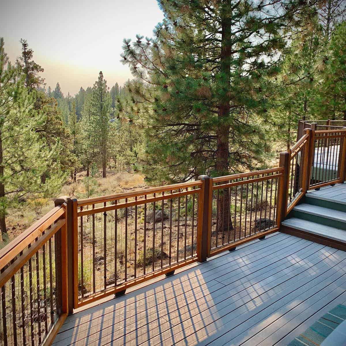two-tone tan and gray deck and railing forest view
