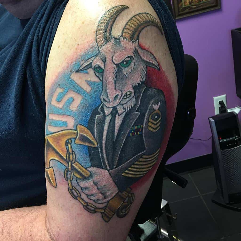 Angry goat in military uniform holding a large gold key marked "USN" with navy anchor in the background