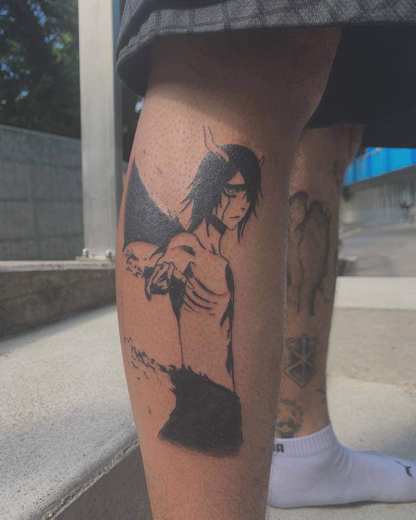 Black ink tattoo of Ulquiorra Cifer from Bleach in his Resurrección form, featuring his horns, bat wings, and intense gaze