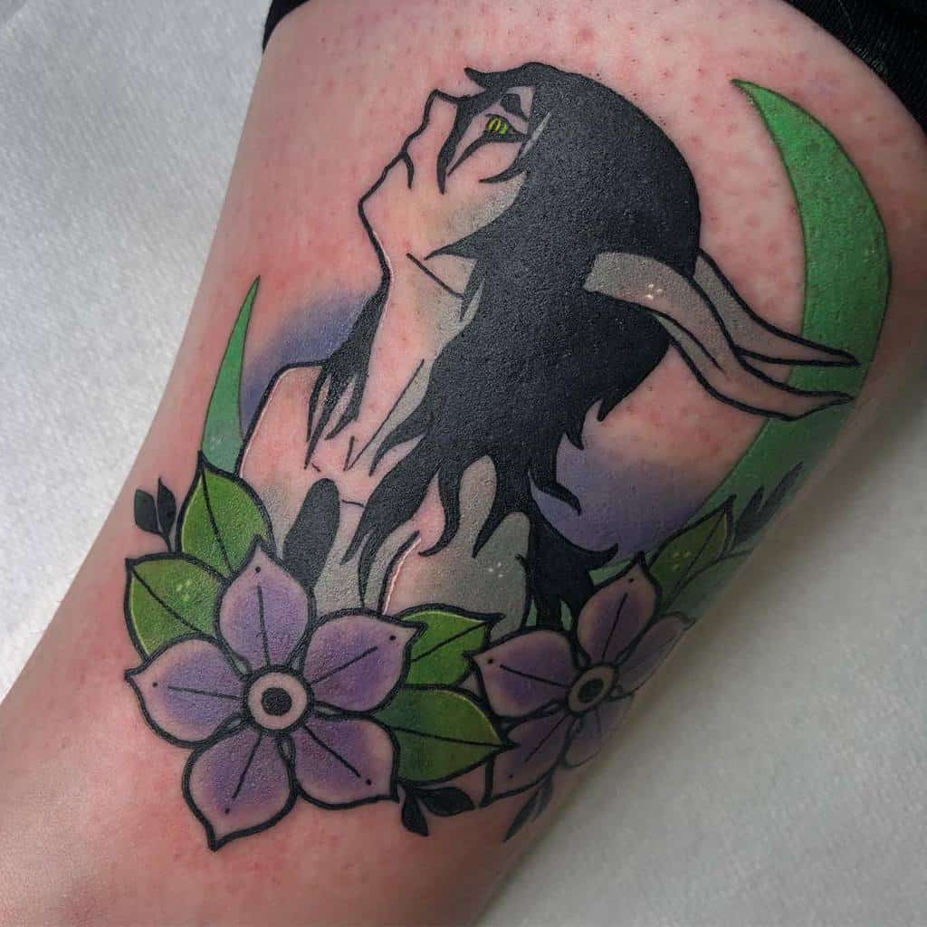 Colorful tattoo of Ulquiorra Cifer from Bleach in his Resurrección form, featuring his hollow mask horns, green crescent moon, and floral elements
