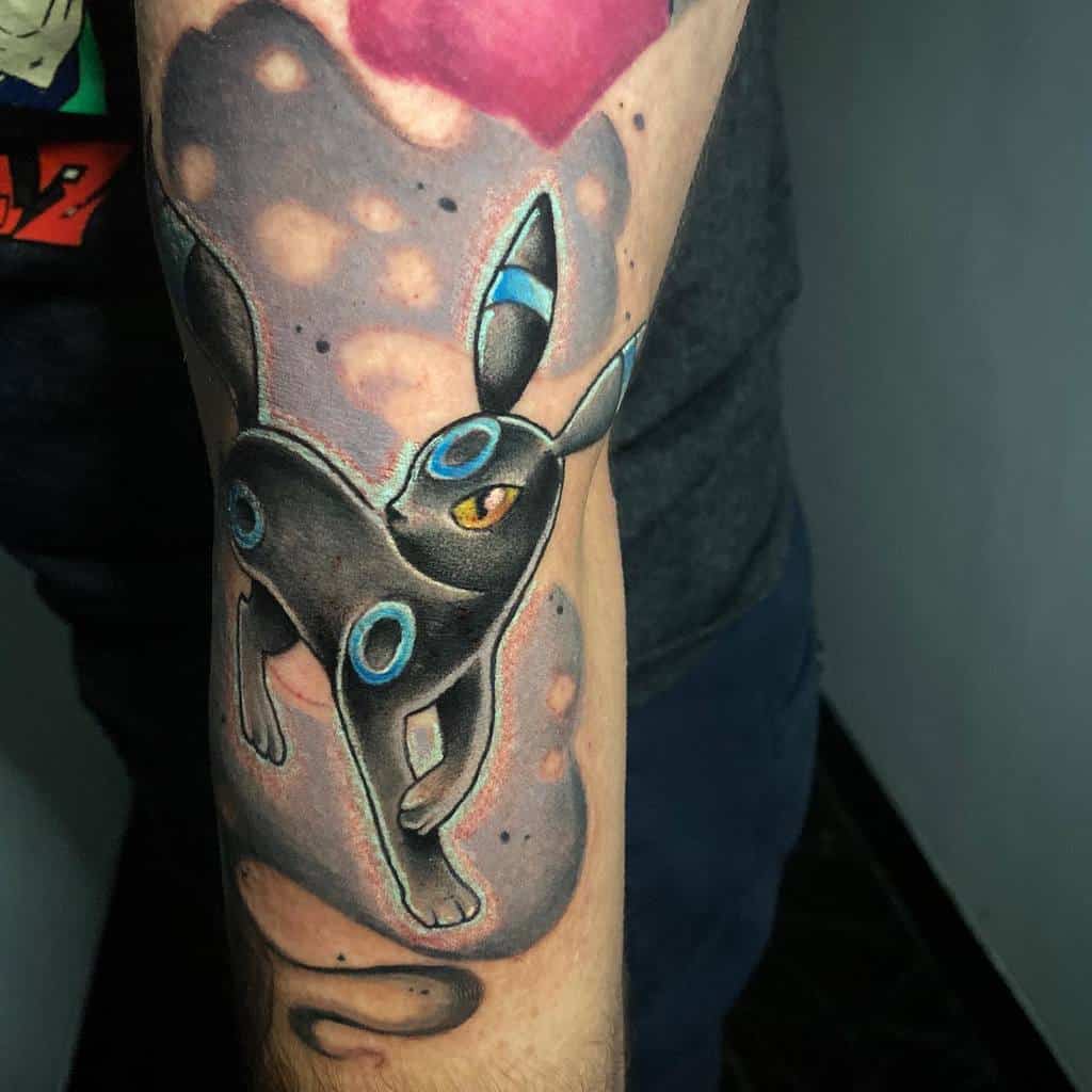 Striking Umbreon tattoo with glowing blue rings and a cosmic background, creating a mystical and bold design