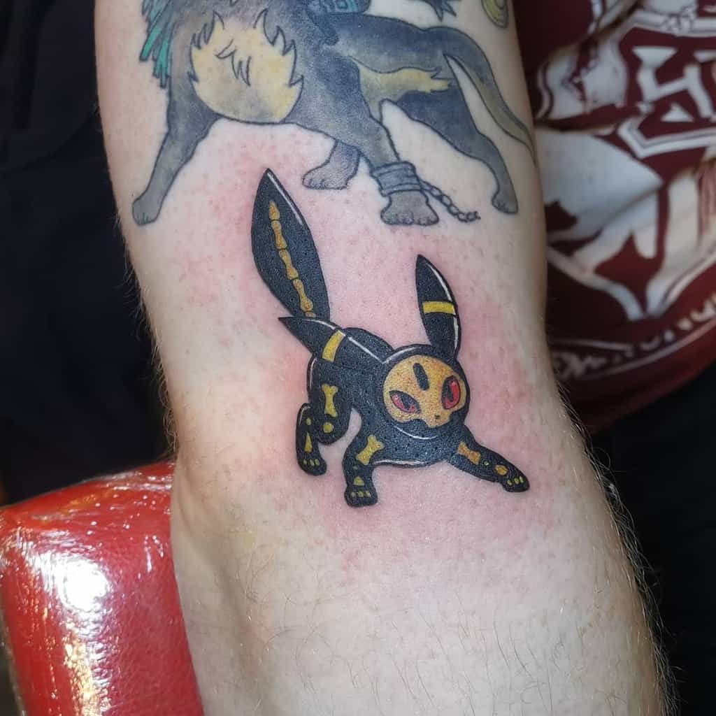 Bold Umbreon tattoo with a stylized skeletal design and glowing red eyes, giving it a mysterious and edgy look