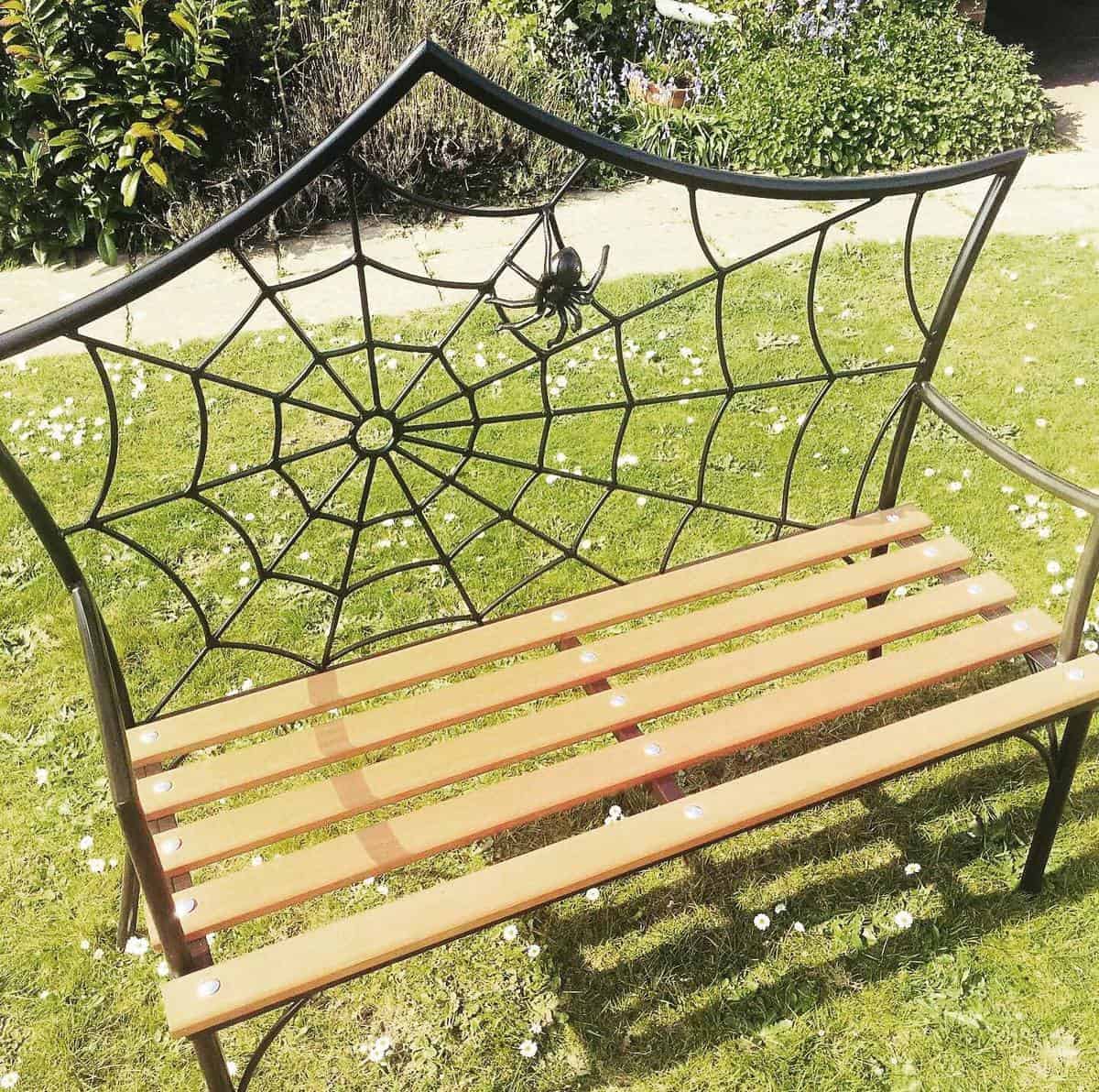 wood bench with spiderweb back