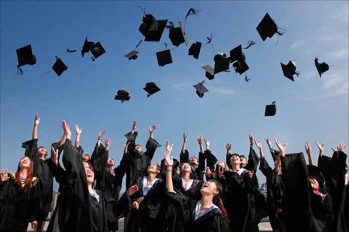 University Graduates Throwing Hats In Air