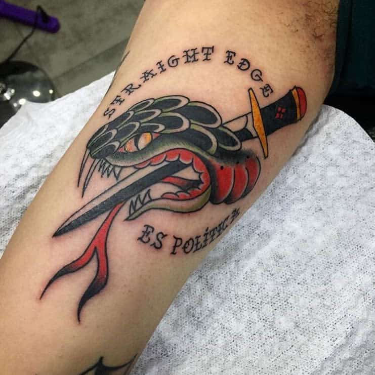 Tattoo of a snake with a dagger through its head, surrounded by "Straight Edge" and "Es Política"