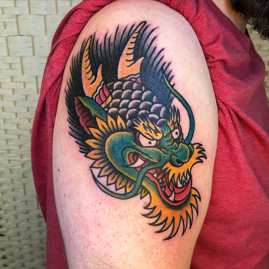 Tattoo of a colorful dragon head on an upper arm