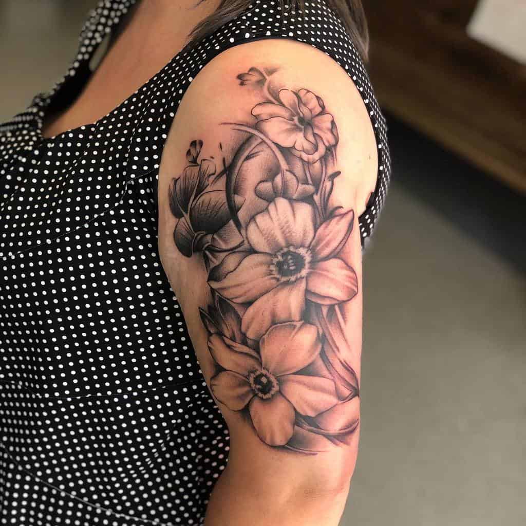 A stunning sleeve tattoo featuring detailed flowers