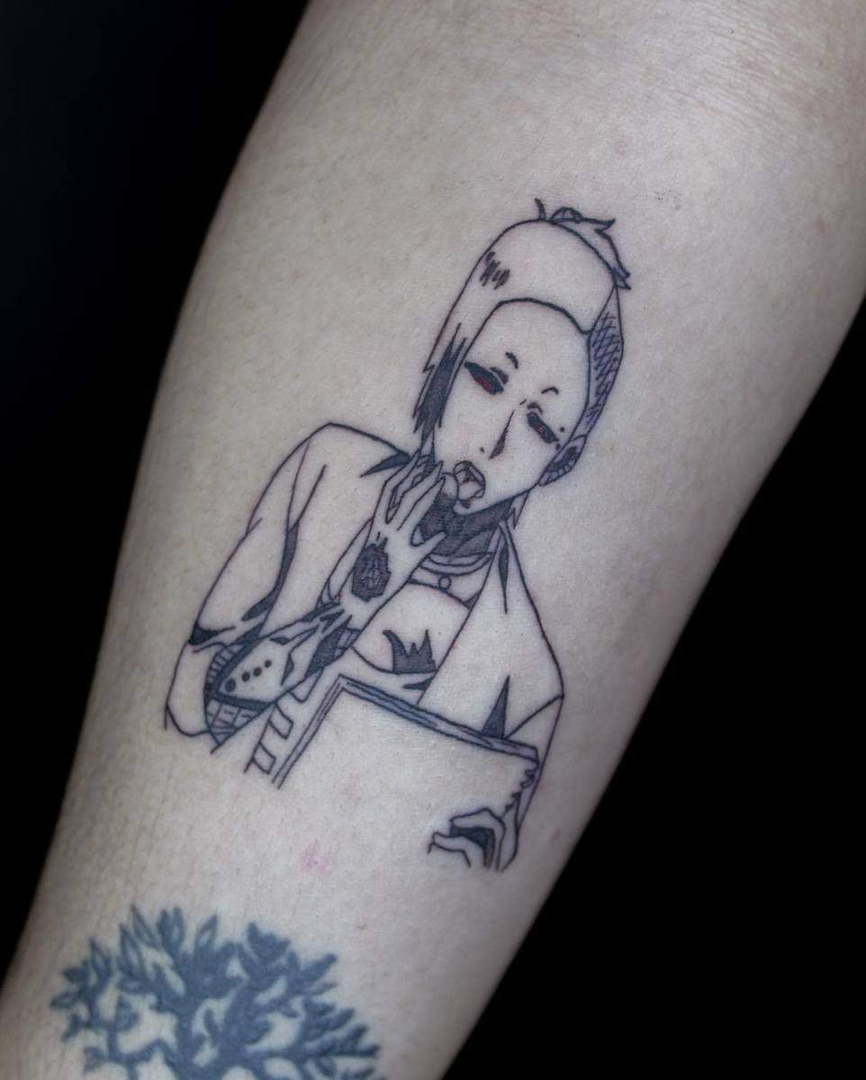 A simple line art tattoo depicting Uta from Tokyo Ghoul, showcasing his characteristic facial expression and tattoos, placed on the forearm