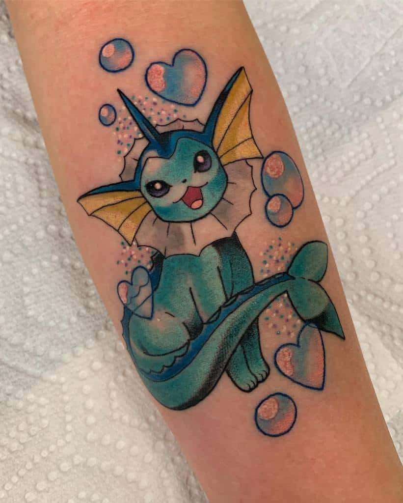 Colorful Vaporeon tattoo with bright blue and yellow tones, surrounded by hearts and bubbles for a playful aquatic vibe