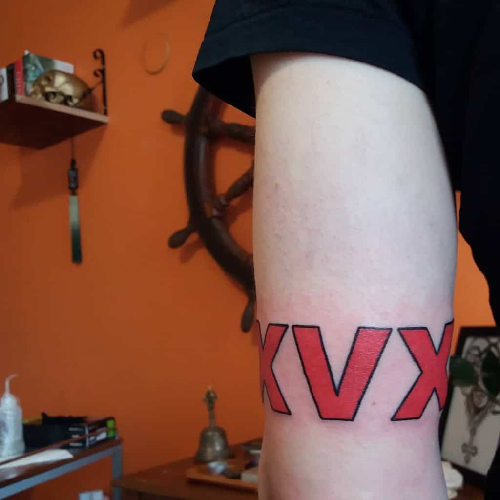 Straight edge tattoo of the letters "XVX" in red with black outline