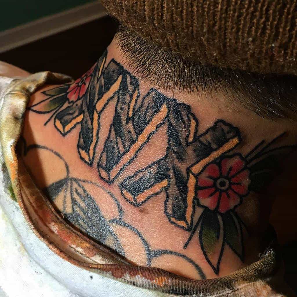 Black and yellow bold "XVX" straight edge tattoo with two flowers and leaves on each sides