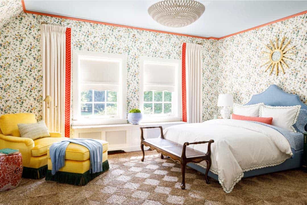 floral wallpaper in large bedroom with yellow accent chair