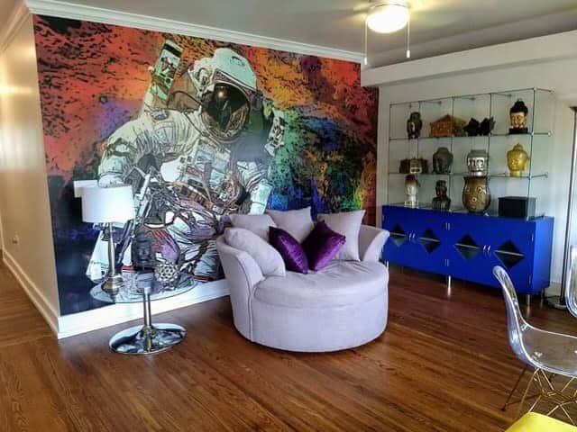 vibrant astronaut wall mural living room purple sofa