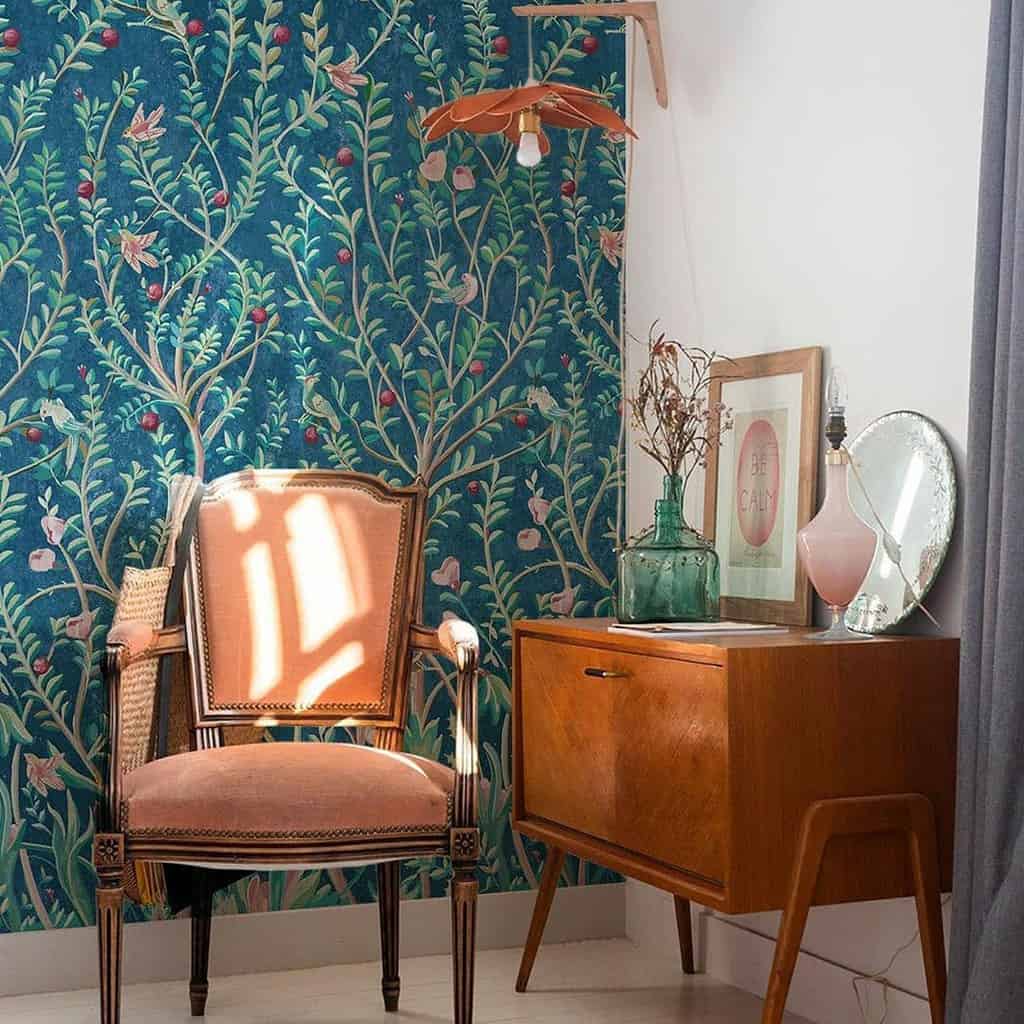 green tree wallpaper vintage furnished living room accent chair rustic wood cabinet