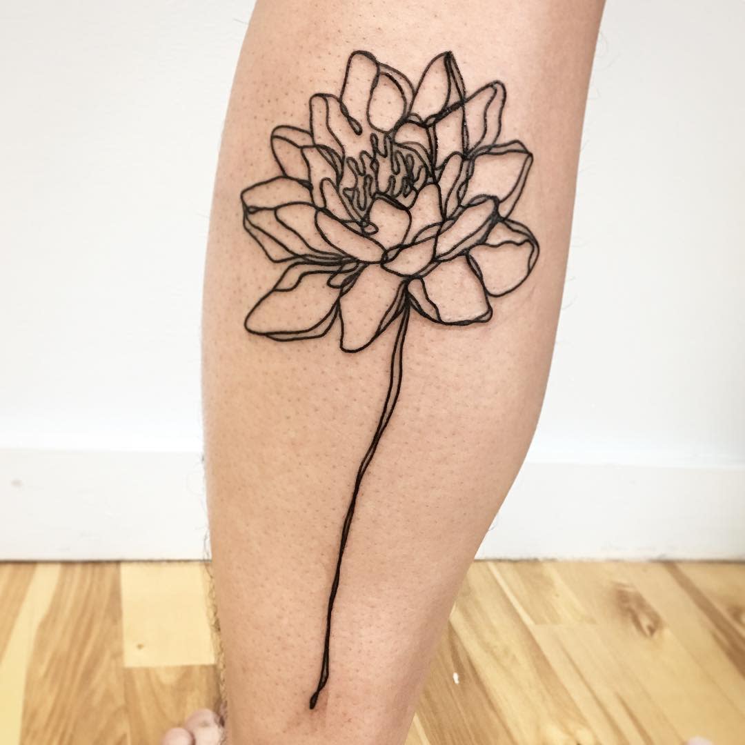 A minimalist single-line water lily tattoo on the calf, featuring an abstract continuous line design that forms the petals and stem, creating a modern and artistic look