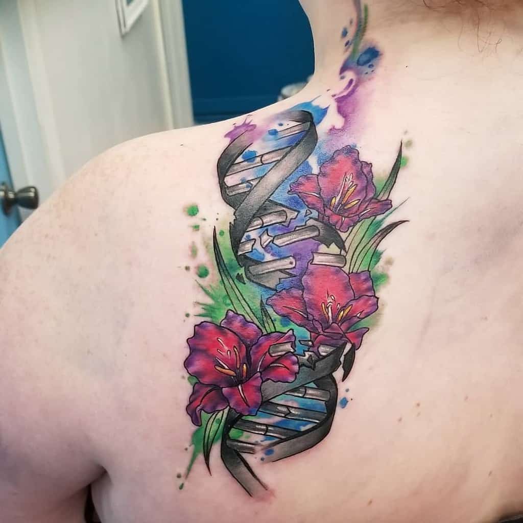 A colorful tattoo of a DNA helix entwined with vibrant red gladiolus flowers on a person's shoulder
