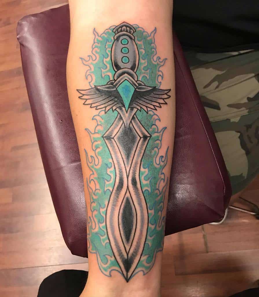Stylized Dungeons & Dragons tattoo of a magical dagger with glowing blue energy, intricate winged details, and a mystical aura