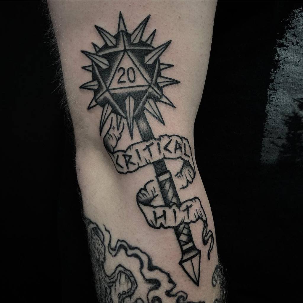 Bold Dungeons & Dragons tattoo of a spiked mace with a d20 die showing a natural 20, wrapped in a 'Critical Hit' banner