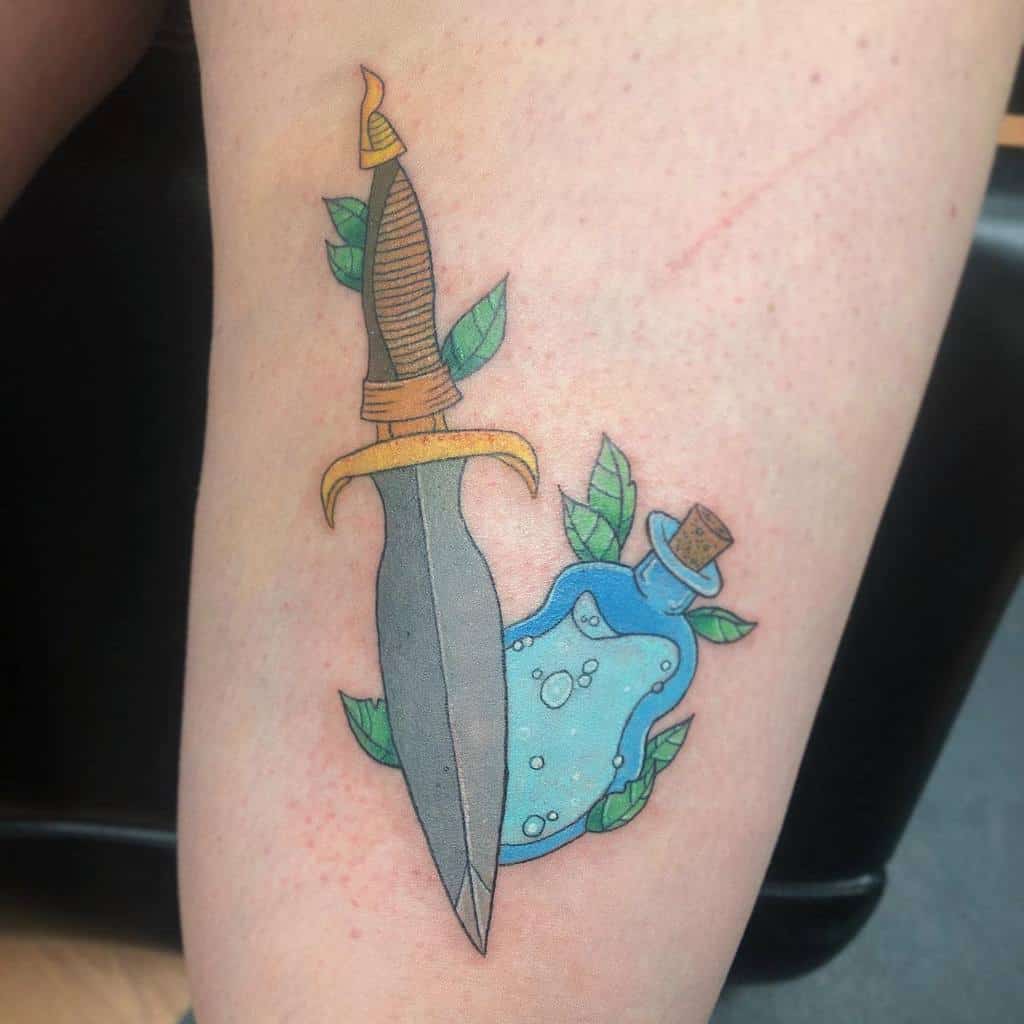 Whimsical Dungeons & Dragons tattoo of a dagger with a flame-shaped hilt and a healing potion, surrounded by delicate green leaves