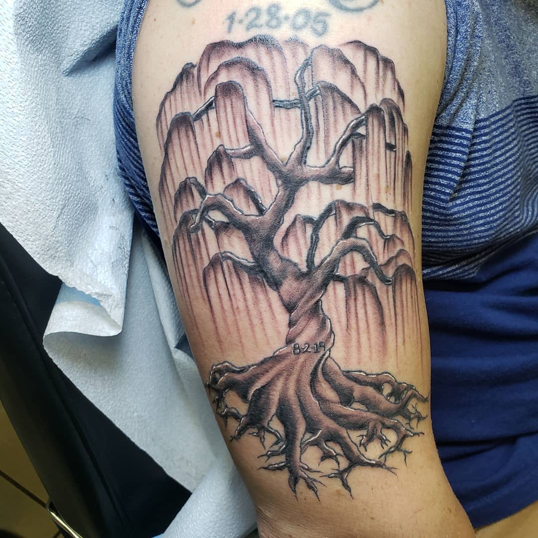 Tattoo of a dead willow tree with bare branches and roots