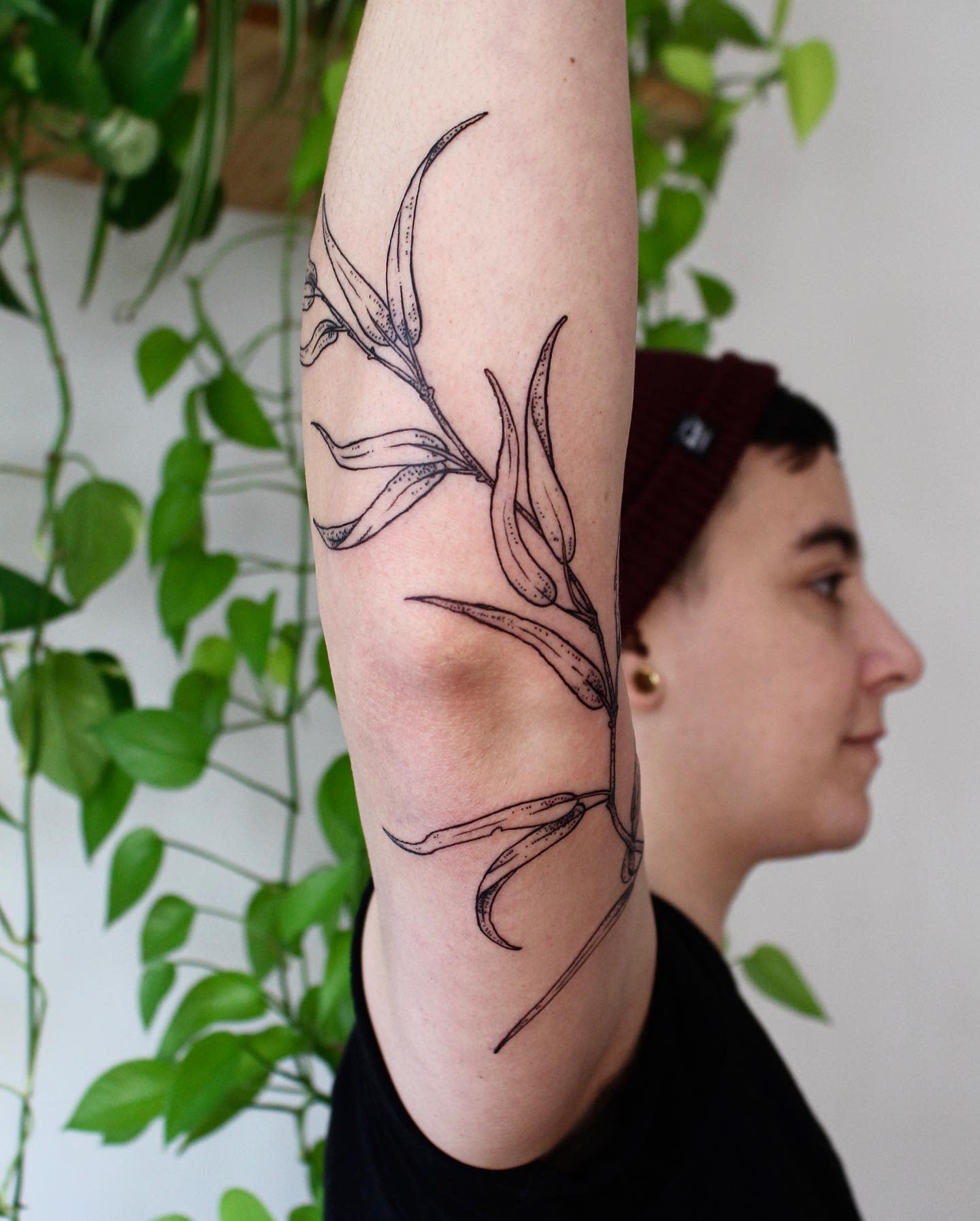 Willow trea leaves tattoo an an arm