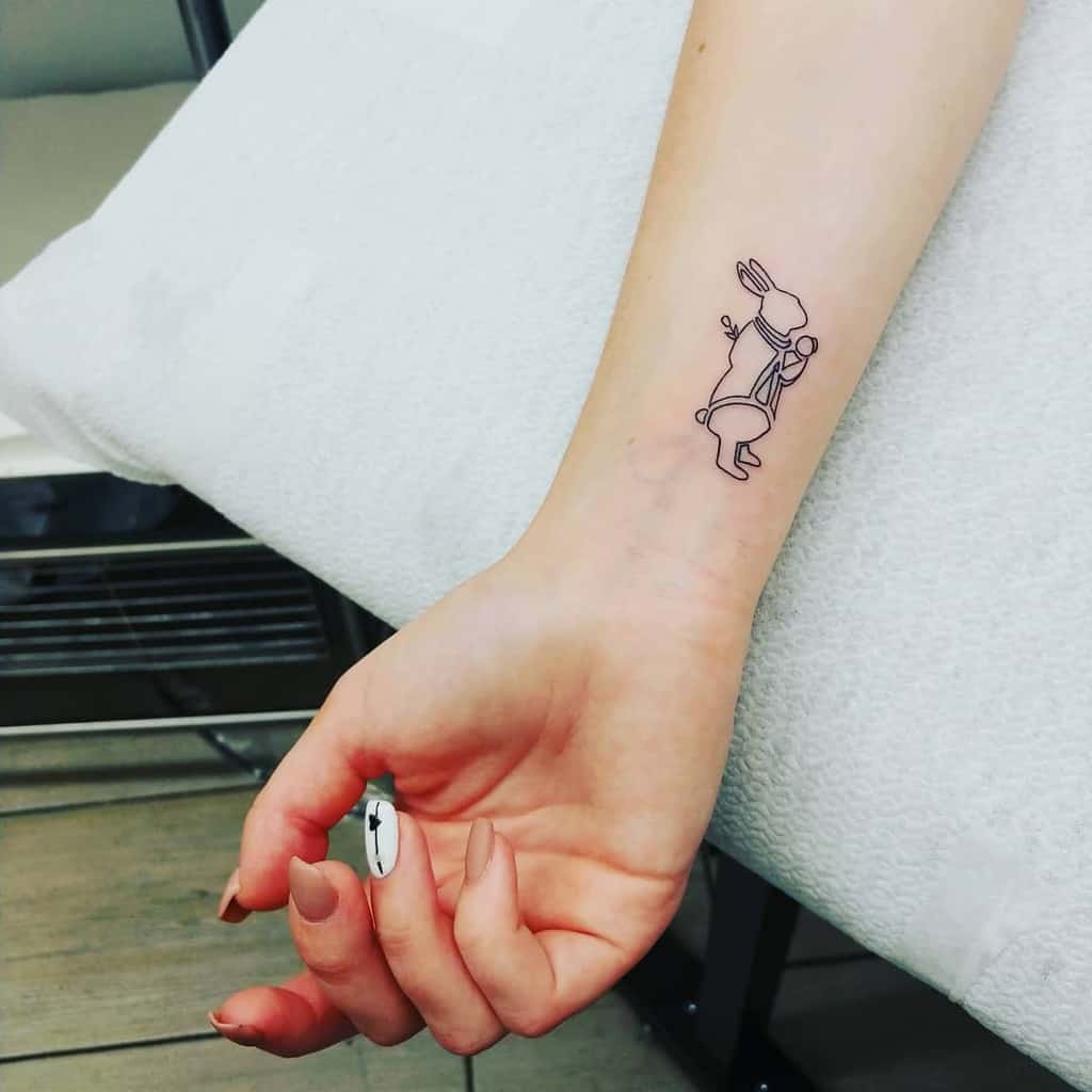 Minimalistic line tattoo of the White Rabbit from Alice in Wonderland, carrying a pocket watch and walking in a simple, elegant style