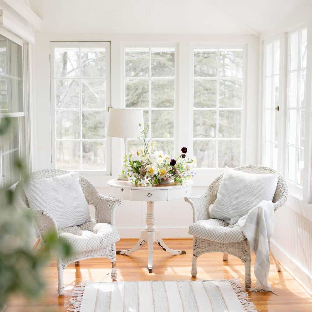 white wicker furniture and table in sunroom