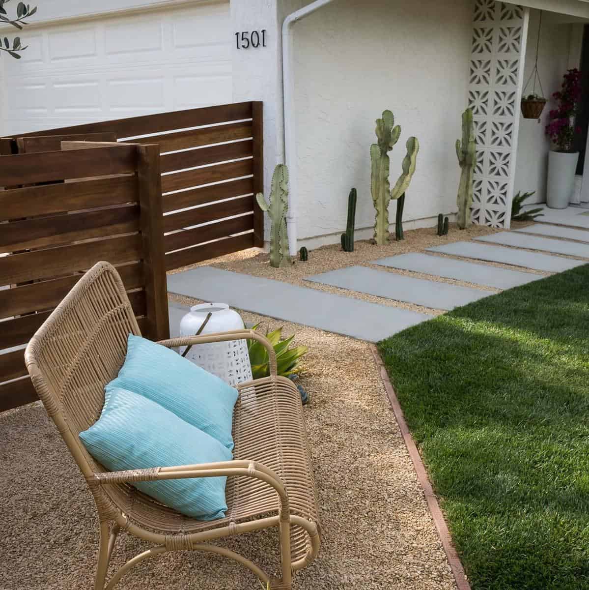 wicker garden bench wood fence cactus