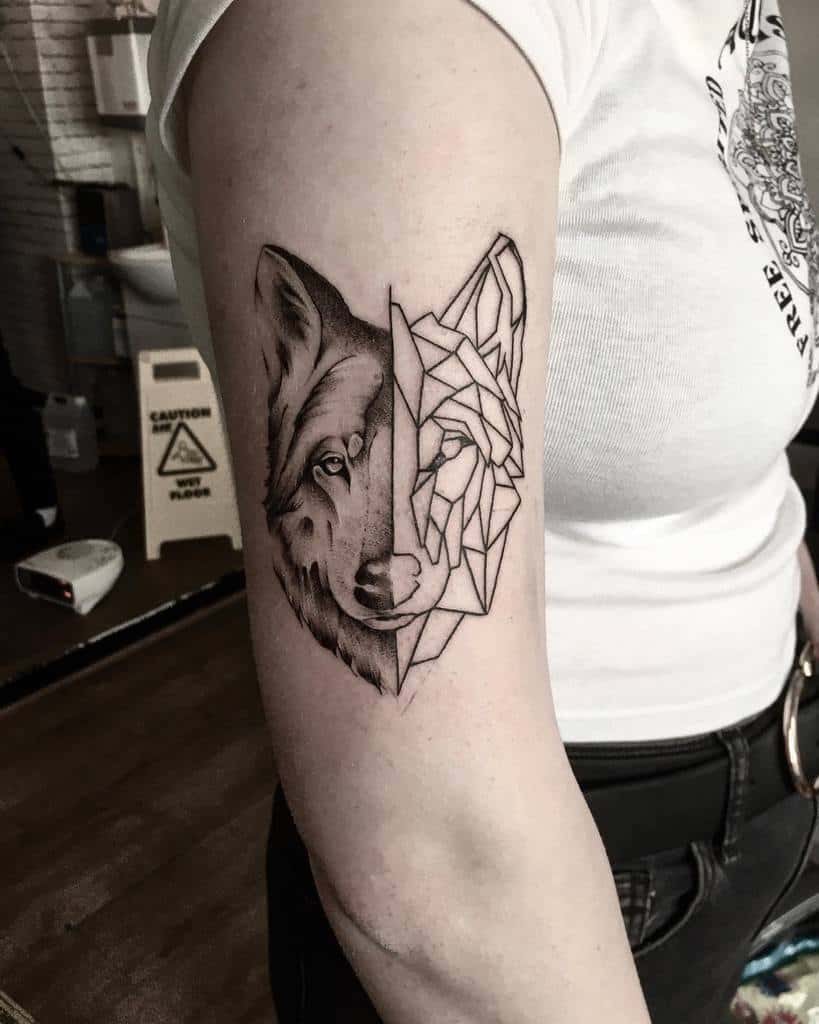 Arm tattoo of a half-realistic, half-geometric wolf on an upper arm