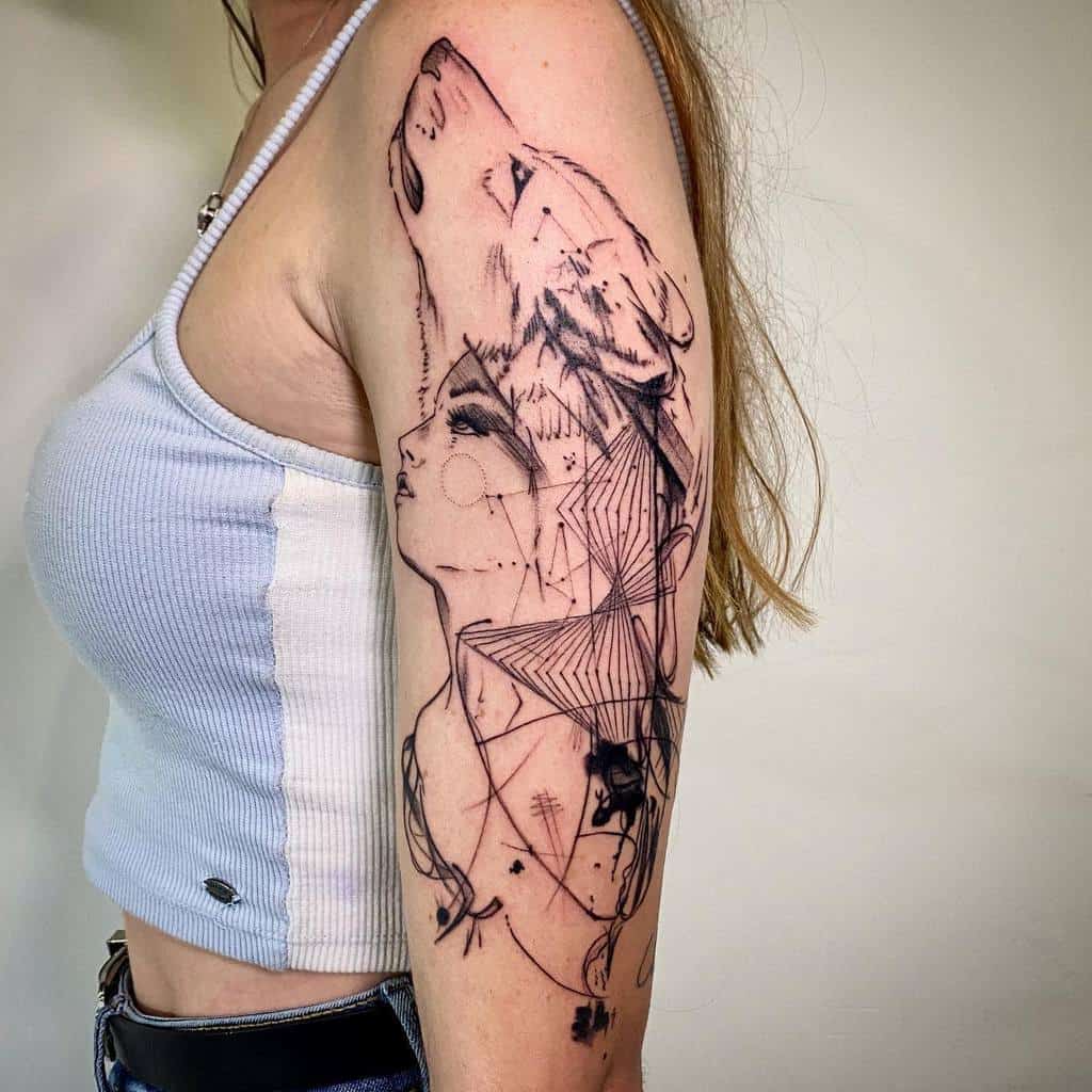 Artistic arm tattoo featuring a woman’s profile intertwined with a howling wolf, incorporating abstract geometric designs and fine linework