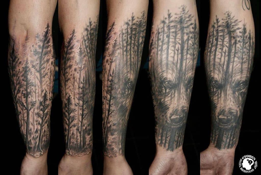 Forearm tattoos with a forest and bear design in black ink