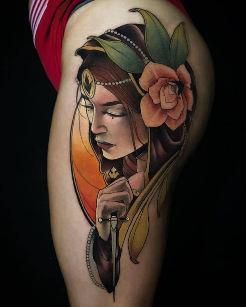 Colorful Art Nouveau tattoo of a veiled woman with a flower in her hair, holding a dagger, framed by warm orange and gold tones
