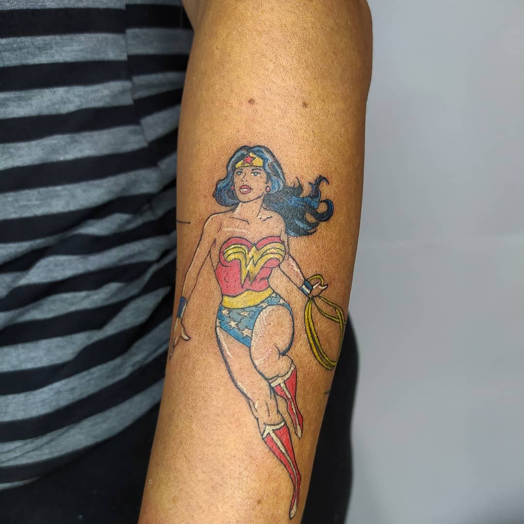 Classic comic-style Wonder Woman tattoo, showing her in action with lasso and flowing hair