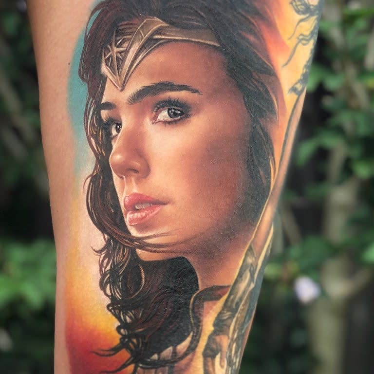 Realistic Wonder Woman tattoo, capturing a detailed portrait with soft shading and intense expression
