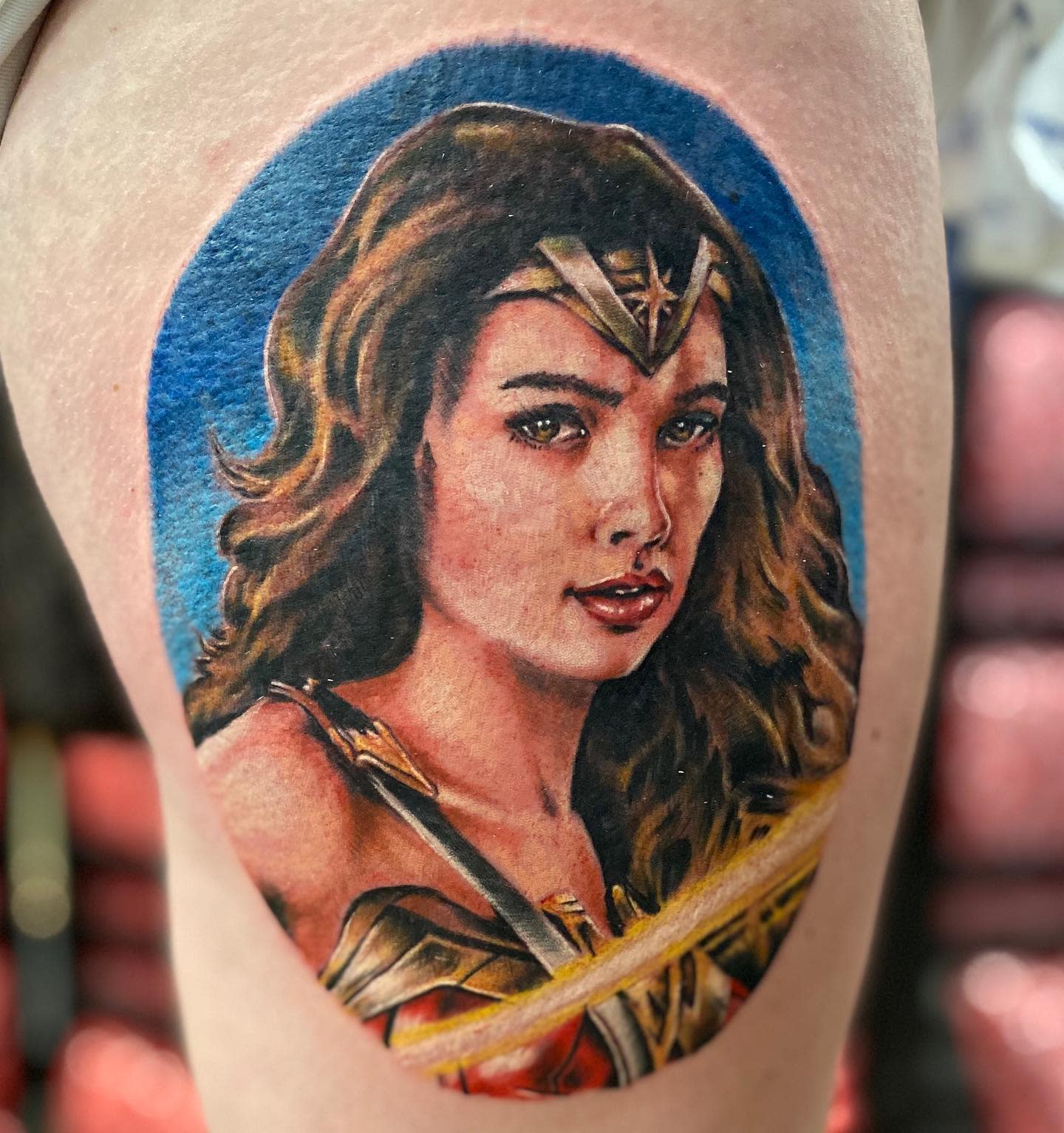 Realistic Wonder Woman tattoo with vivid colors, showing her determined expression and powerful stance