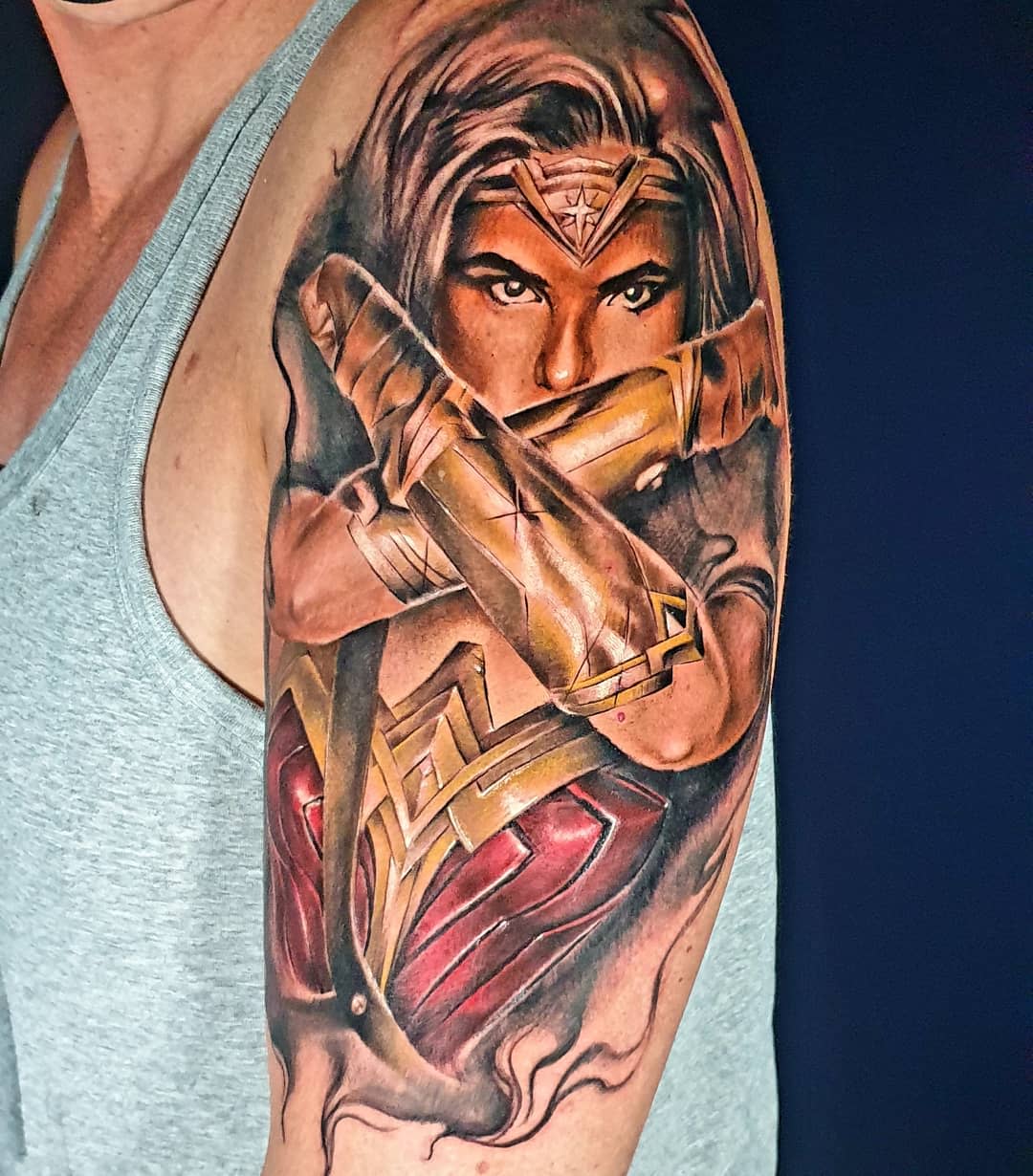 Realistic Wonder Woman tattoo with a powerful pose, showcasing her iconic crossed-arm stance and intense focus